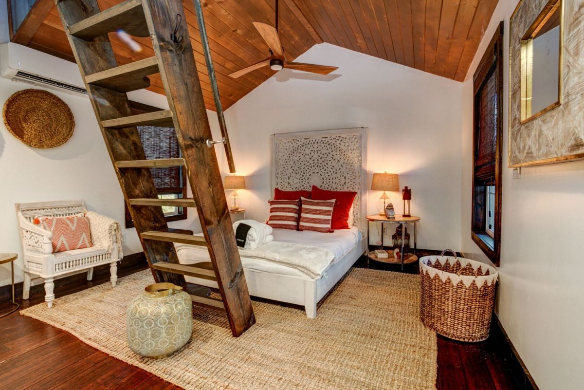 Cottage bedroom with loft ladder and warm light